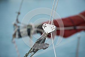 Sailboat ropes wooden pulley rigs. Part of a sail boat. Close-up view of sailboat ropes, pulleys and ropes on the mast, Yachting s