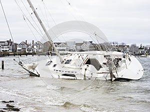 A sailboat run aground after breaking free of its moorings photo