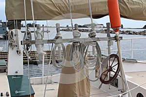 Sailboat Sail, Steering Wheel, and Weathered Ropes