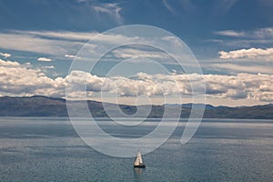 Sailboat sailing alone on Lake Ohrid on a bright summer day, Macedonia FYROM