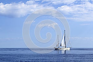 Sailboat sailing on blue sea horizon ocean