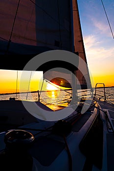 Sailboat sailing in the Mediterranean Sea at sunset photo