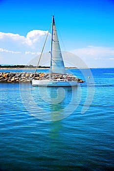Sailboat sailing in the morning with blue cloudy s