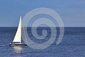 Sailboat sailing on the sea with a clear blue sky