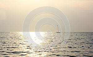 sailboat sailing at sea in the evening near the sunset.