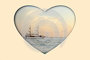 Sailboat sailing on the sea at sunset in the shape of a heart, collage