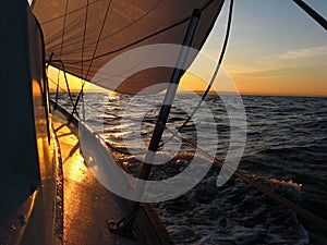 Sailboat sailing at sunrise