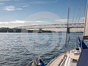 Sailboat sailing towards Old Little Belt Bridge linking Jutland and Funen in Southern Denmark, Denmark