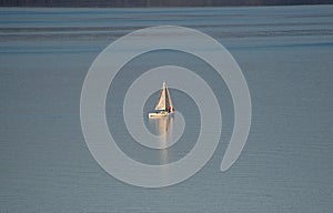 Sailboat sailing in a water lake of the central Italy