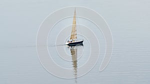 Sailboat sailing wit shadow