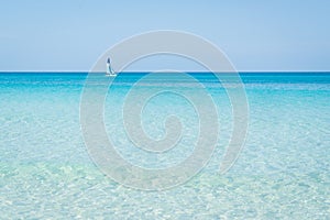 Sailboat sails alone in the Caribbean sea