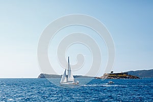 Sailboat sails past the coast of Mamula Island