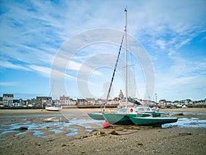 Sailboat on the sand at low tide, village of the Croisic on Guerande peninsula France photo