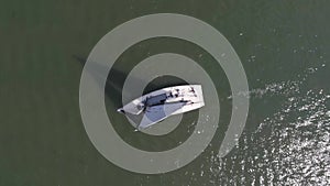 Sailboat in the sea near the port. Footage. White sailboat in the sea