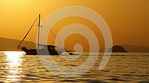 Sailboat at sea. Seascape golden sunrise over the sea. Yacht sailing in the sunrise time.