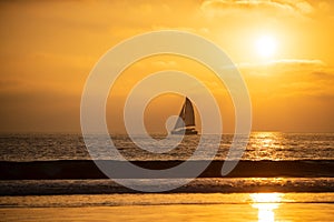 Sailboat at sea. Seascape golden sunrise over the sea. Yacht sailing in the sunrise time. Sea landscape view with a