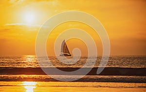 Sailboat at sea. Seascape golden sunrise over the sea. Yacht sailing in the sunrise time. Sea landscape view with a