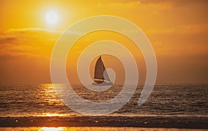 Sailboat at sea. Tropical beach sea ocean with sunset or sunrise for summer travel vacation. Ocean seascape.