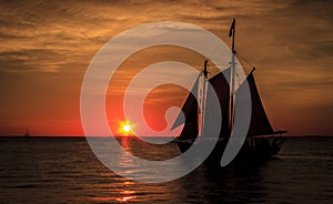 Sailboat silhouetted against sunset