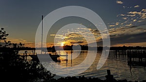 Sailboat silhouetted against the sunset, Tarpon Springs, Florida, Anclote River