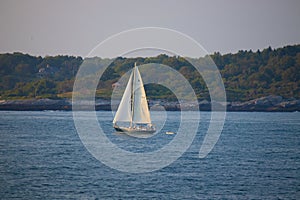 Sailboat slowly drifting across the bay photo