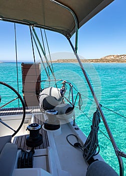 Sailboat stern, yacht deck, blue sea water background