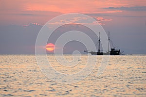 Sailboat during sunset above the sea