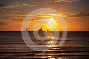 Sailboat at sunset on a tropical sea
