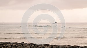 Sailboat and surfers in distance