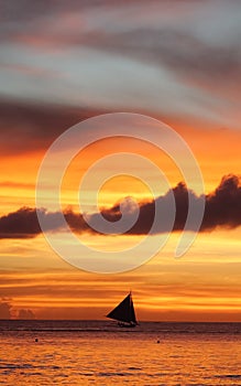Sailboat under a fiery Boracay Island sunset