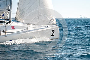 Sailboat under white sails during the regatta competition