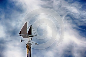 Sailboat weathervane in the sky