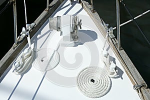 Sailboat white bow with bollard and spiral rope photo