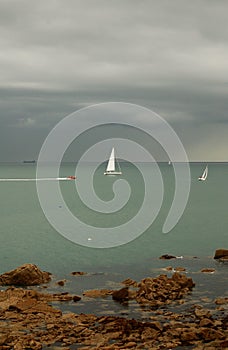 Sailboats against a cloudy sky