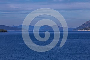 sailboats cruises on the Adriatic Sea in the region of Dubrovnik, Croatia, with islands in the background, sunny day, clear