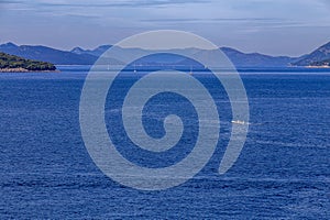 sailboats cruises on the Adriatic Sea in the region of Dubrovnik, Croatia, with islands in the background, sunny day, clear