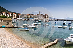 Sailboats dotting the harbor on a summer day of Vis Island, Croatia
