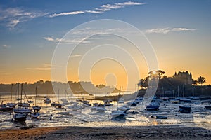 Sailboats at low tide and sunset on the beach of St Briac near St Malo, Brittany France