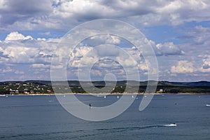 Sailboats and motorboats on the clear blue water