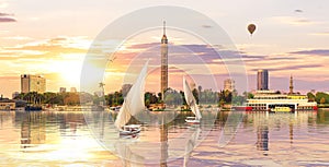 Sailboats in the Nile in front of Cairo TV Tower at sunset, Egypt, Africa