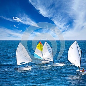 Sailboats Optimist learning to sail in Mediterranean at Denia