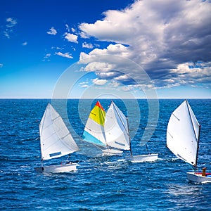 Sailboats Optimist learning to sail in Mediterranean at Denia photo