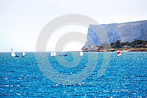 Sailboats Optimist learning to sail in Mediterranean at Denia