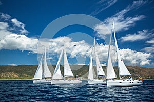 Sailboats participate in sailing regatta 12th Ellada Autumn 2014 among Greek island group in the Aegean Sea