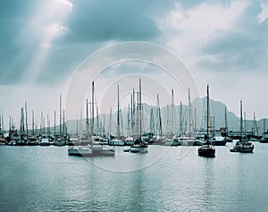 Sailboats and pleasure boats in the porto grande bay of the historic city Mindelo. Clodscape with Sunrays