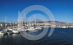 Sailboats at the port of Altea with view on mountain range with old city and cathedral, Altea, Costa Blanca, Spain