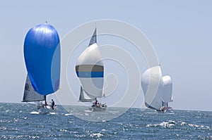 Sailboats Racing In The Blue Ocean Against Sky