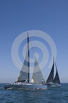 Sailboats Racing In The Blue Ocean Against Sky