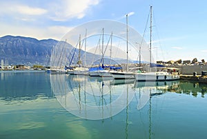 Sailboats reflected on sea at Kalamata Greece photo