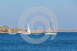 Sailboats at rocky archipelago